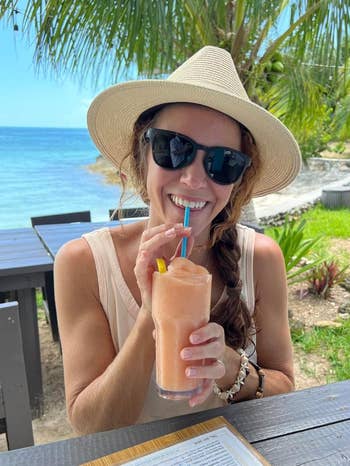 reviewer successful  a sunhat and sunglasses enjoying a frozen portion  by the formation  with thenar  trees successful  the background