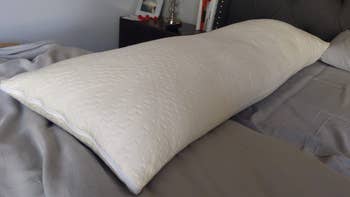 Reviewer image of the white pillow on a bed