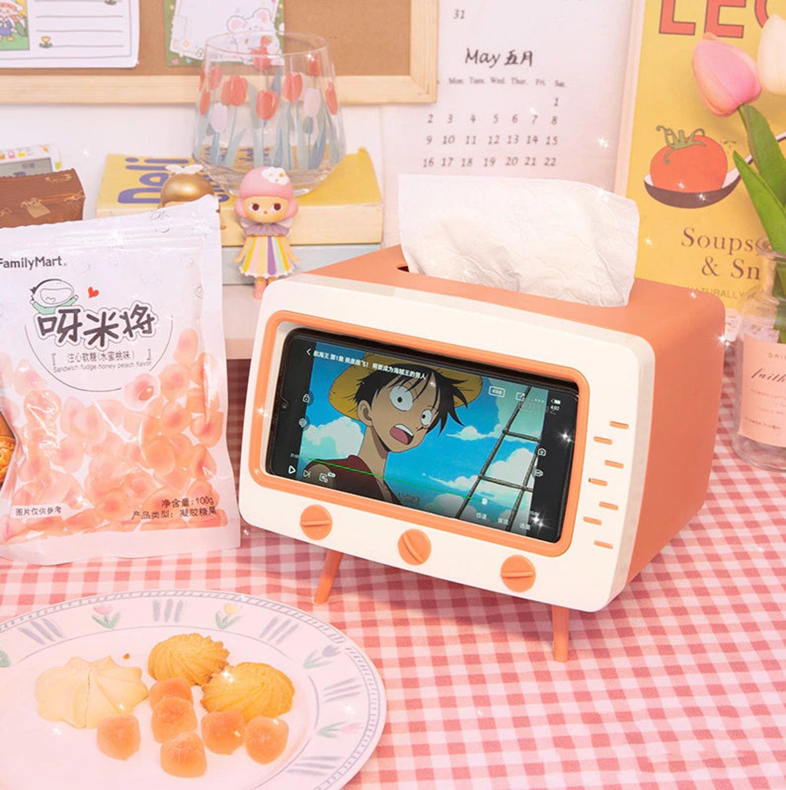the retro tv tissue box on a desk with a phone in the holder