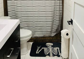 the skeleton bath mat in a reviewer's bathroom