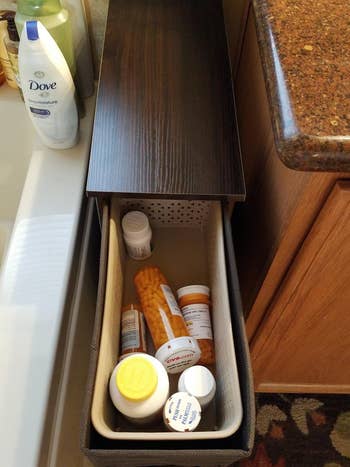 same reviewer's organizer with drawer open showing it storing pill bottles