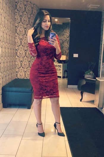 reviewer mirror selfie wearing red dress and black satin pumps