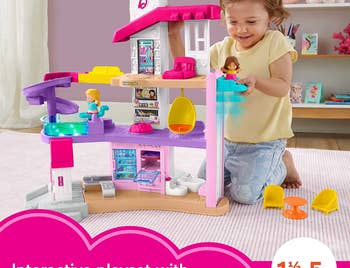Child model playing with white, pink, purple accented playhouse