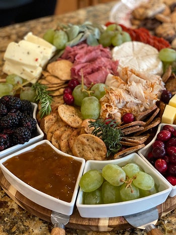 reviewer's charcuterie board up close packed with food