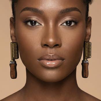 Woman wearing comb-shaped earrings with glossy finish, looking straight  into the camera. Perfect for a stylish accessory feature