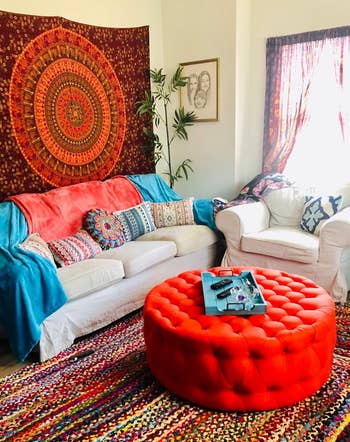the red tufted ottoman/table in a reviewer's living room