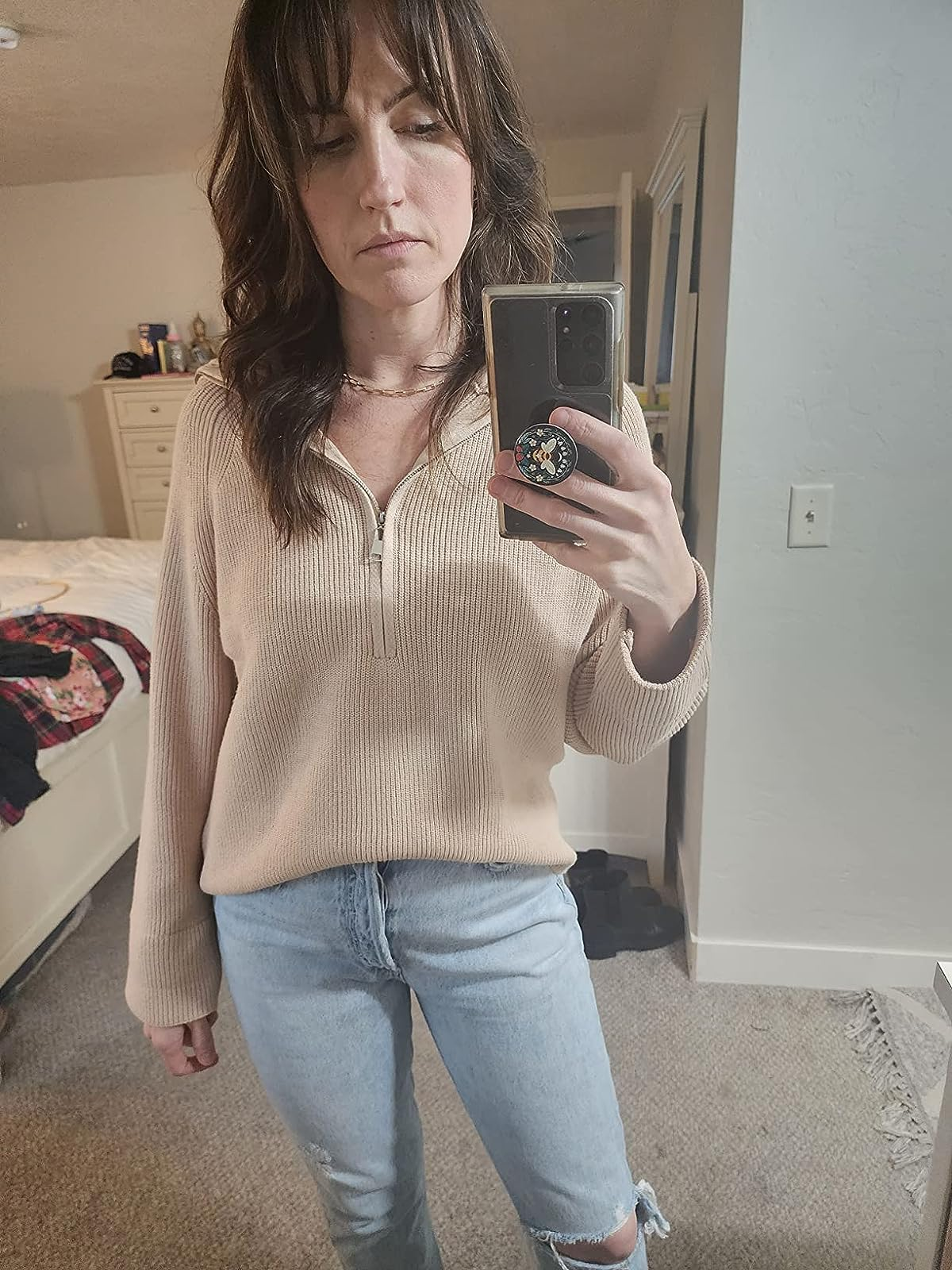 a reviewer wearing the sweater successful  tan 