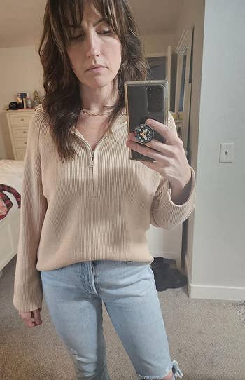 a reviewer wearing the sweater in tan 
