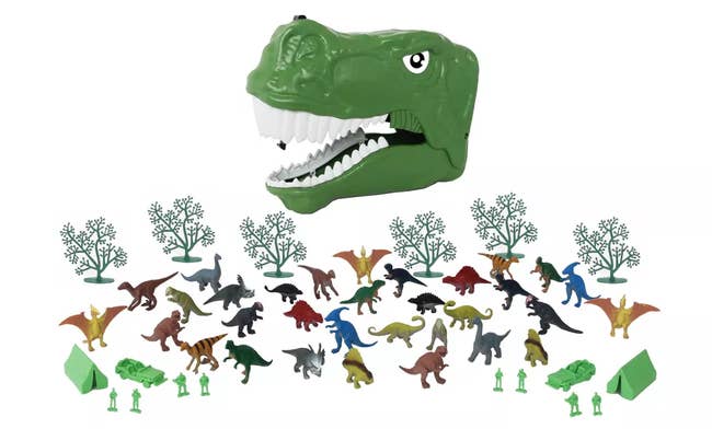 Green plastic dinosaur head case with smaller dino figures, trees, and campers