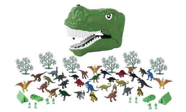 Green plastic dinosaur head case with smaller dino figures, trees, and campers