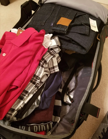 before image of clothes taking up space in a suitcase 