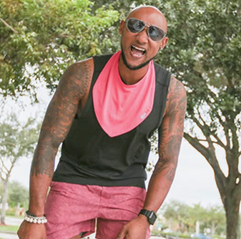 Model wearing a pink bandana-shaped sweat towel around their neck 