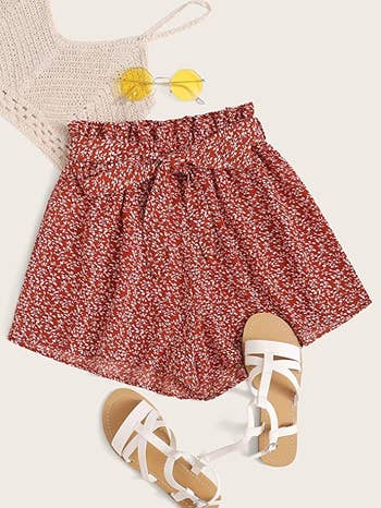 elastic waist shorts with a red floral pattern and a matching tie belt