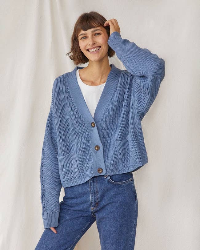 model in the blue cardigan with a white top underneath