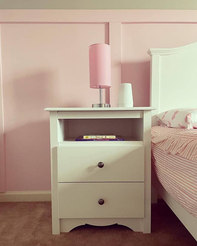 reviewer photo of white two-drawer nightstand in pink-themed bedroom 