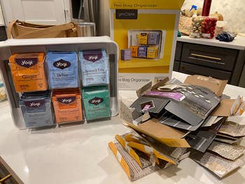 the tea stand next to a pile of empty tea boxes