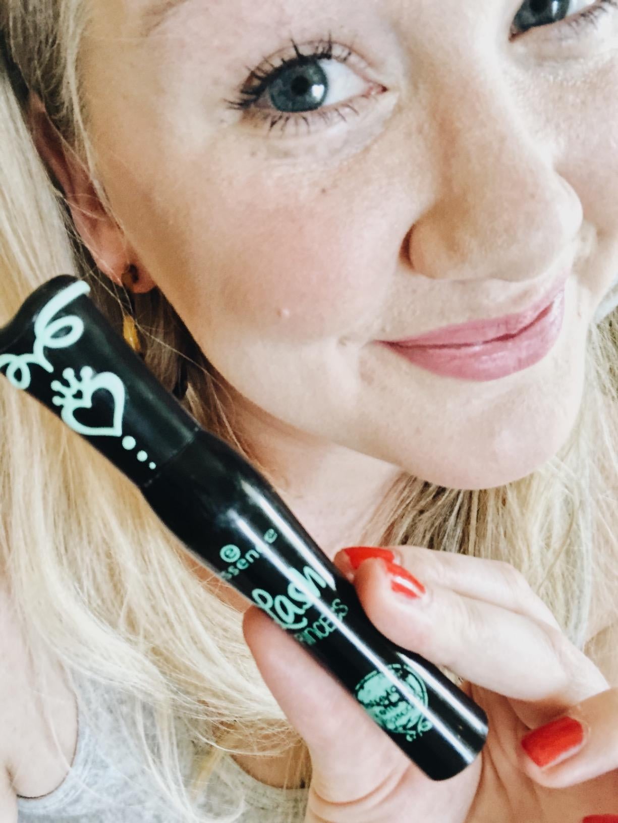 Reviewer holding product in hand and showing off lashes