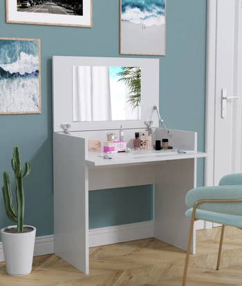 the same desk open as a vanity mirror and storage inside