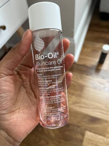 reviewer holding bottle of bio oil
