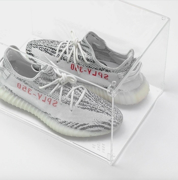 clear shoe box with yeezy sneakers inside