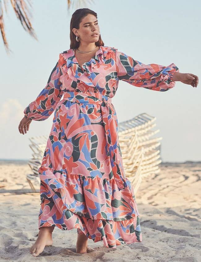 model wearing the floral dress on the beach