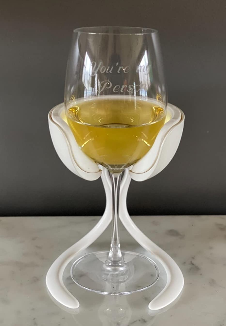 a reviewer photo of a glass of wine inserted in the freestanding chill cradle 