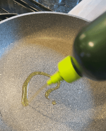 GIF of Ross pouring the Graza Sizzle Olive Oil into a silver skillet
