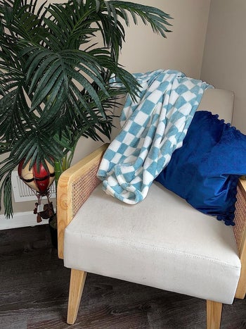 reviewer image of a light blue and white checkered blanket on a chair