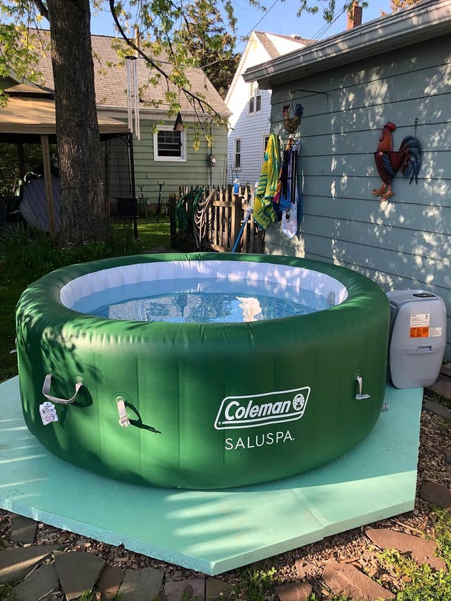 Inflatable Coleman SaluSpa hot tub set up in a backyard next to a house