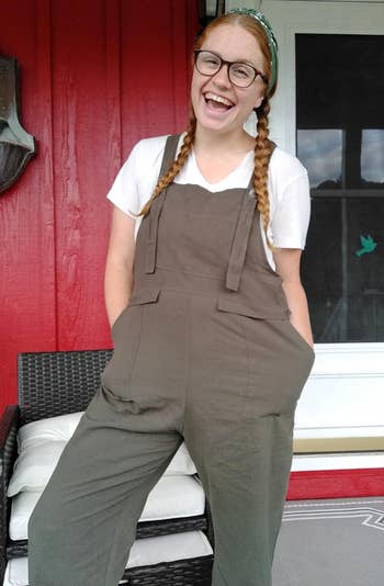 reviewer in gray baggy overalls