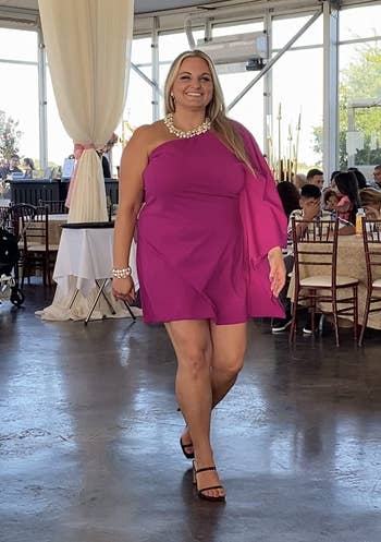 reviewer in the fucshia one-sleeve shift dress