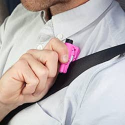A model using the pink key chain to cut their seat belt