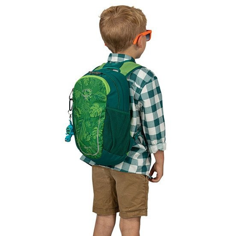a child model wearing a leaf-printed backpack