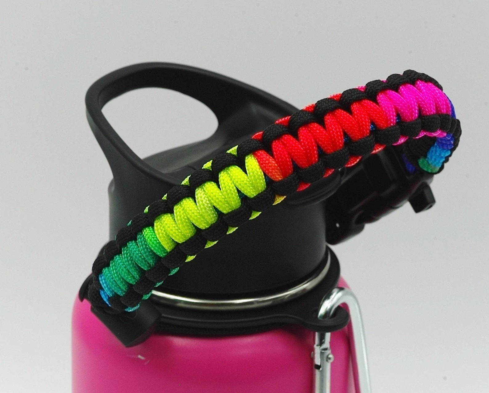A pink bottle with a rainbow handle