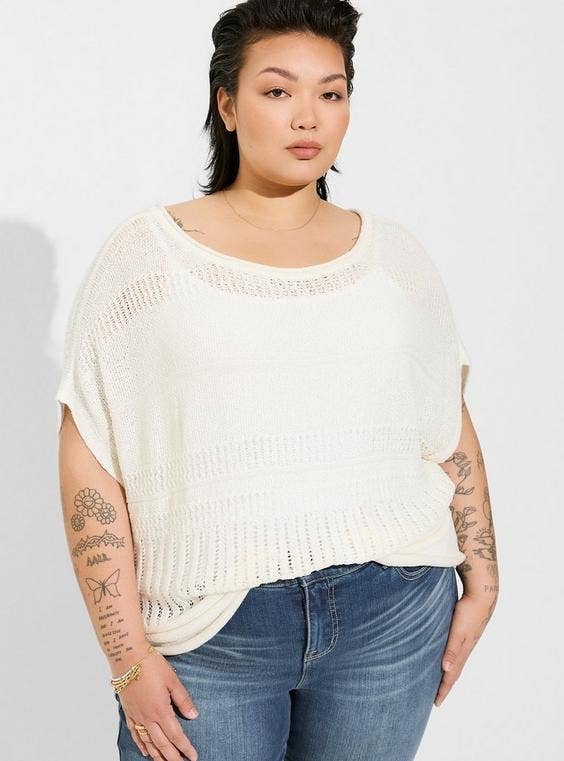 model in the cream colored pointelle sweater