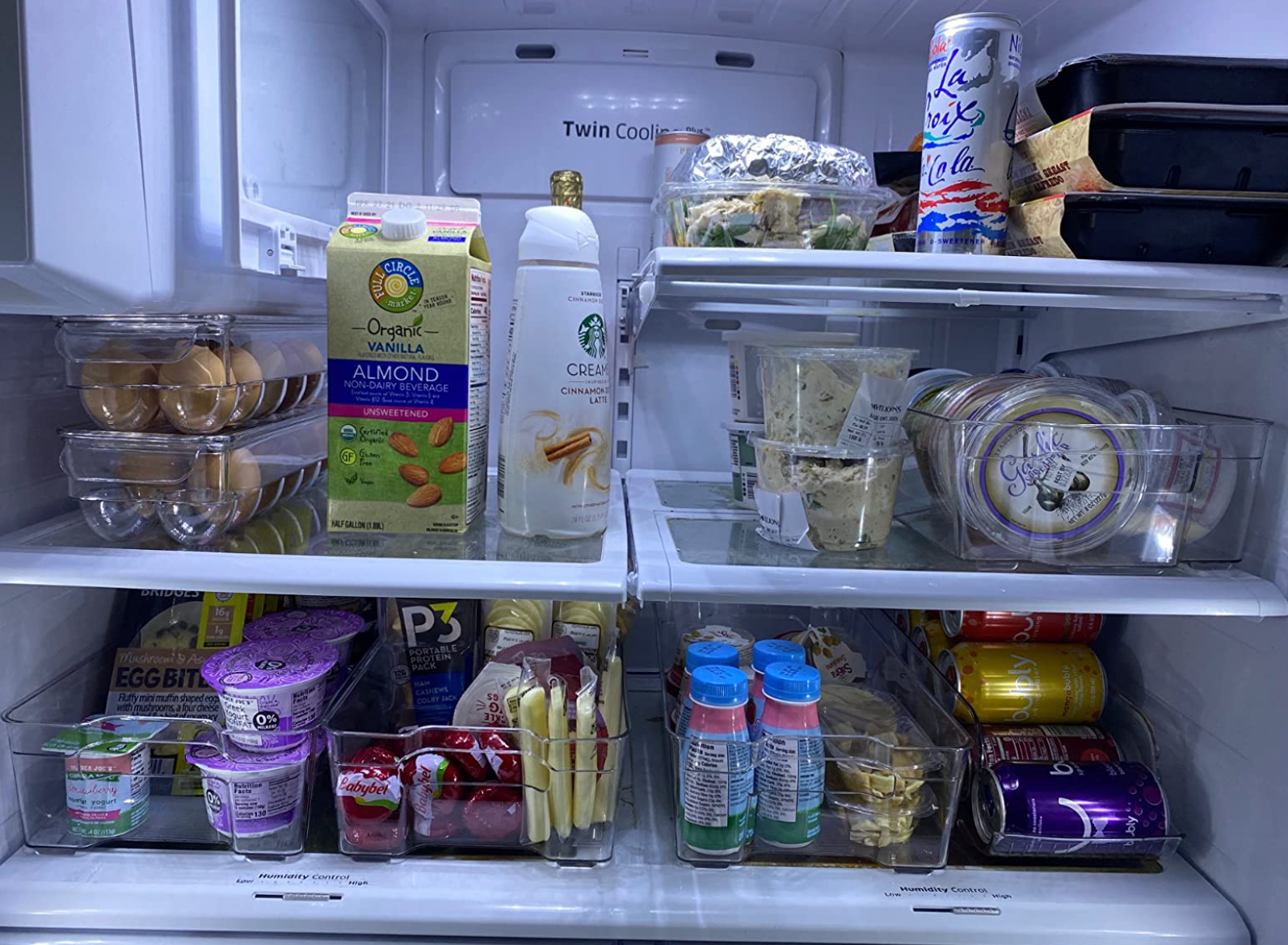 A reviewer's fridge looking organized with the storage bins