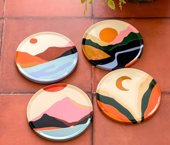 A close up of four coasters with various nature-inspired images