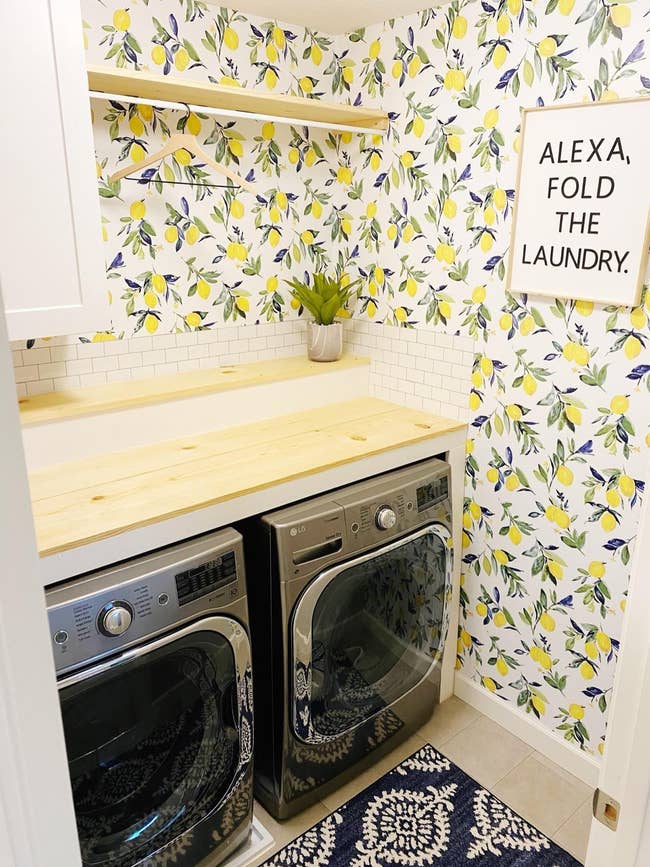reviewer photo of the lemon wallpaper in their laundry room
