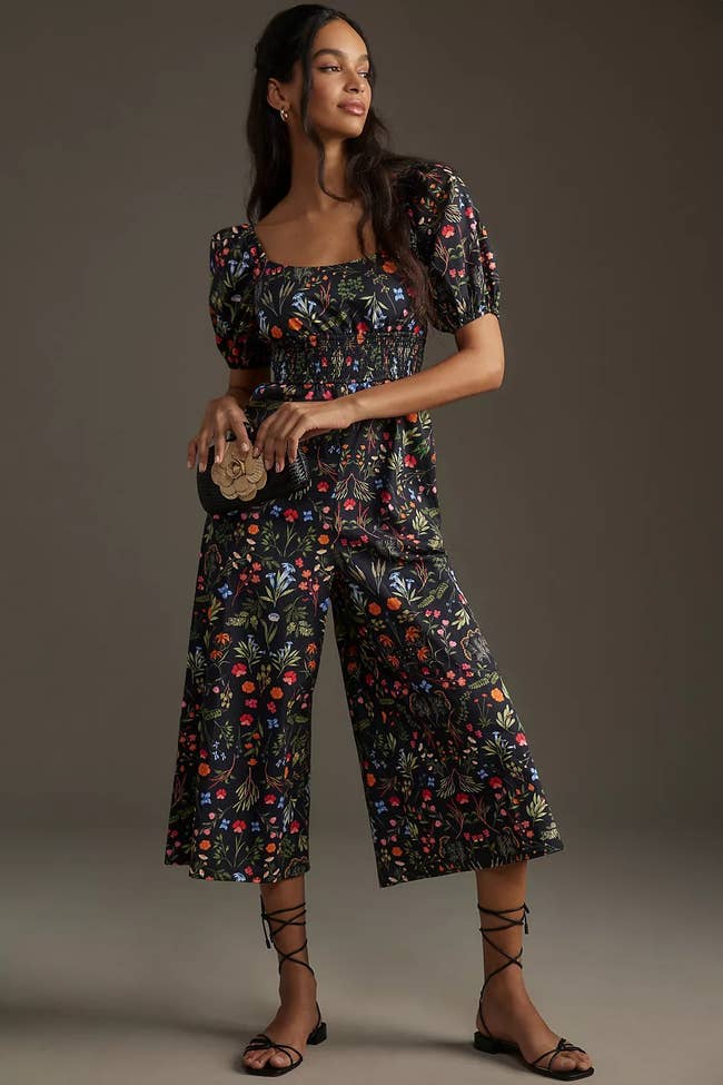 Model showcasing a puff-sleeve jumpsuit with floral pattern