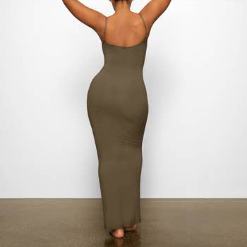 model showing the back view of the olive dress