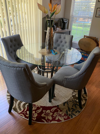 blue gray high back chairs with black legs around a table