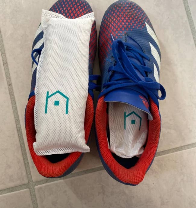 reviewer's blue and red shoes with the deodorizer bags 