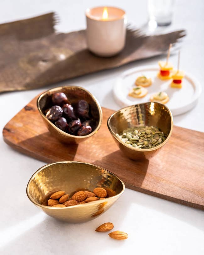 wooden tray and three metal rounded bowls