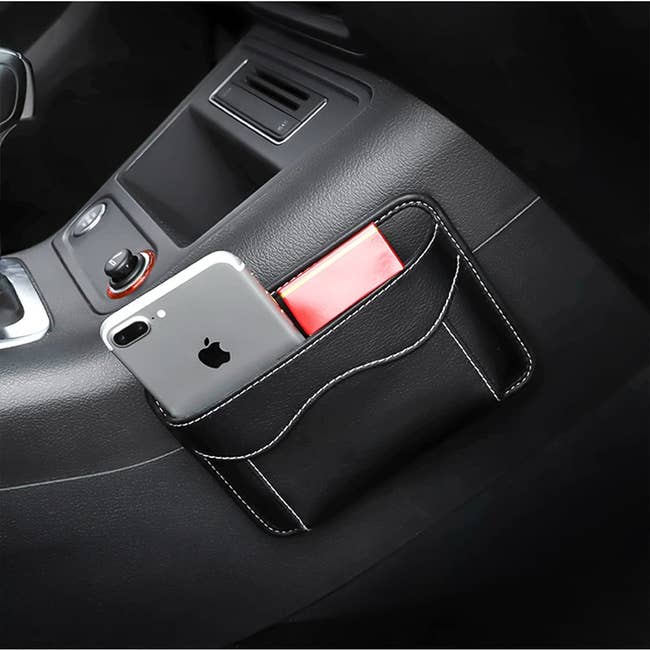The storage pouch on the side of console holding phone and wallet