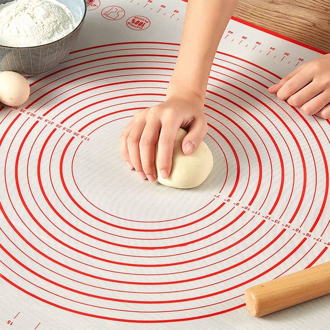 model rolling out dough on a mat