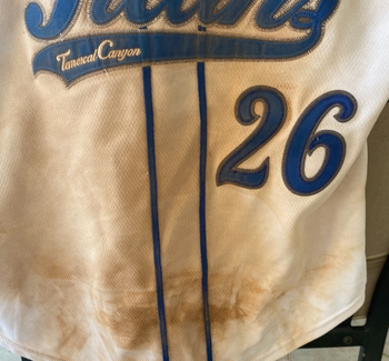 reviewer image of a dusty, dirty softball uniform