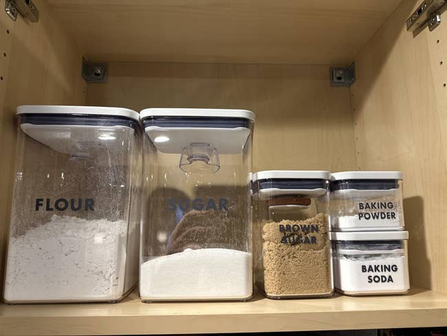 Labeled room  containers successful  a cupboard filled with flour, sugar, brownish  sugar, baking powder, and baking soda
