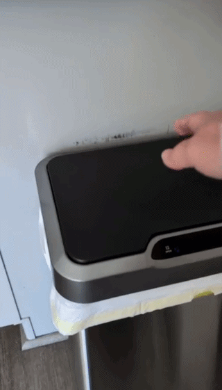 A hand demonstrates a touchless sensor trash can lid opening, highlighting ease and convenience for home use