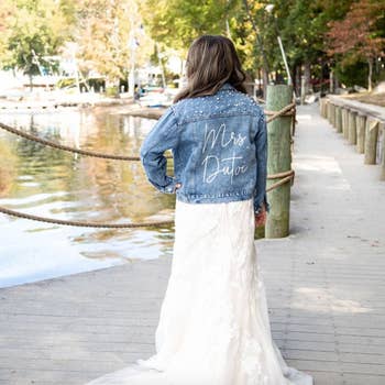 a model wearing the custom jacket over a wedding dress