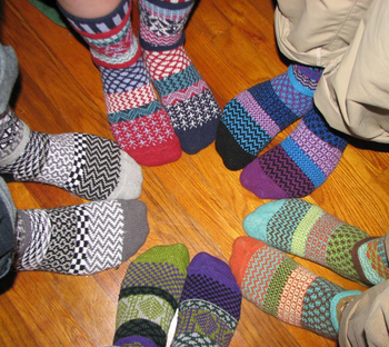 Reviewer image of five people wearing the socks
